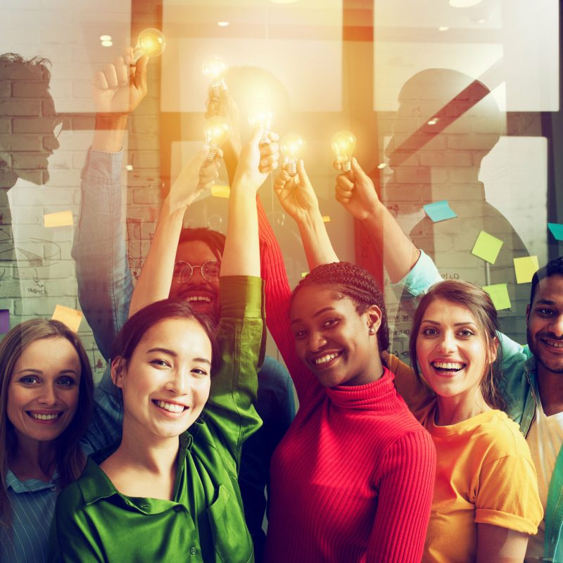 Teamwork and brainstorming concept with businessmen that share an idea with a lamp. Concept of startup